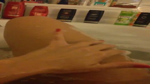 MILF caliente metiéndose el dedo en el coño en la bañera